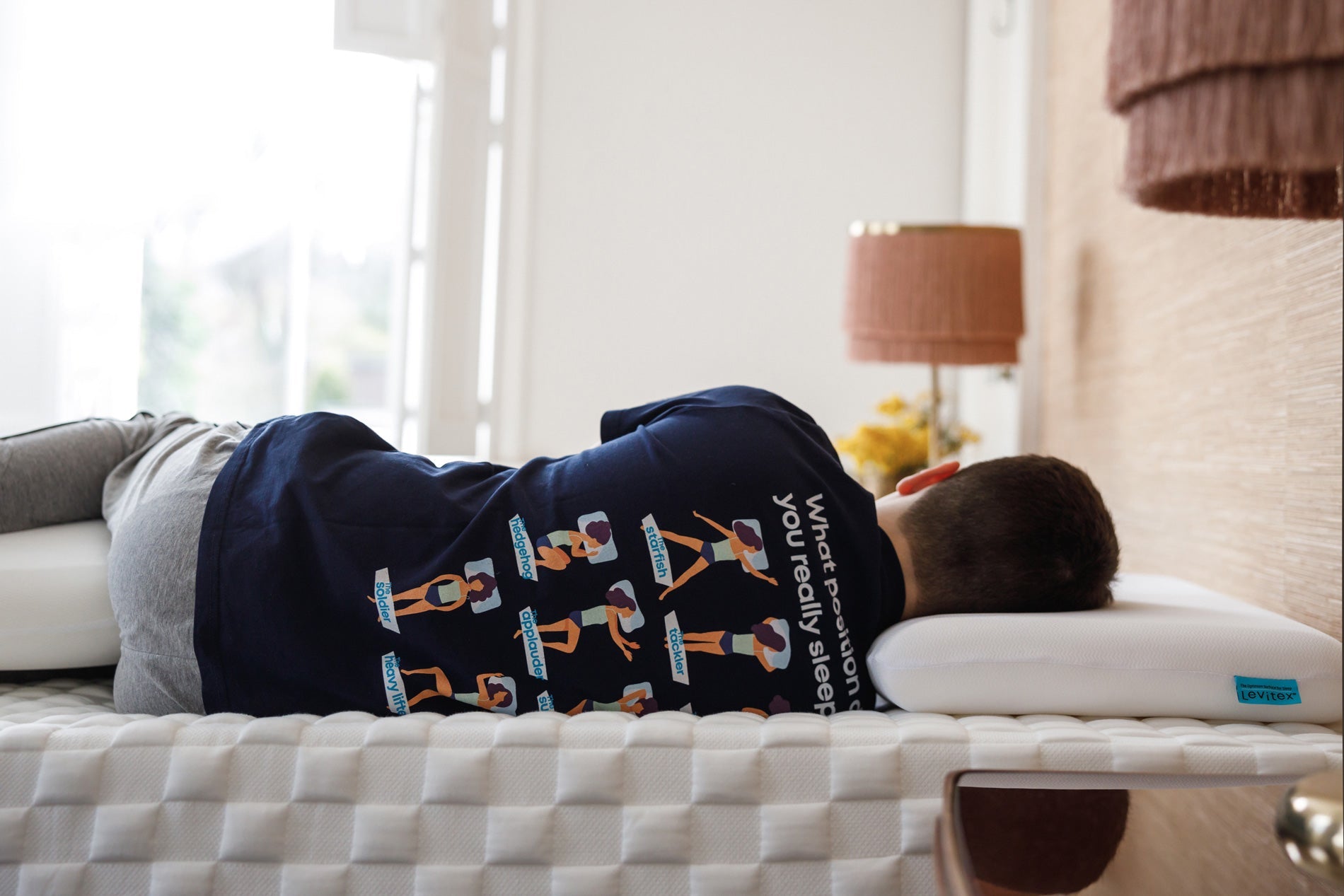 man sleeping on his side in bed