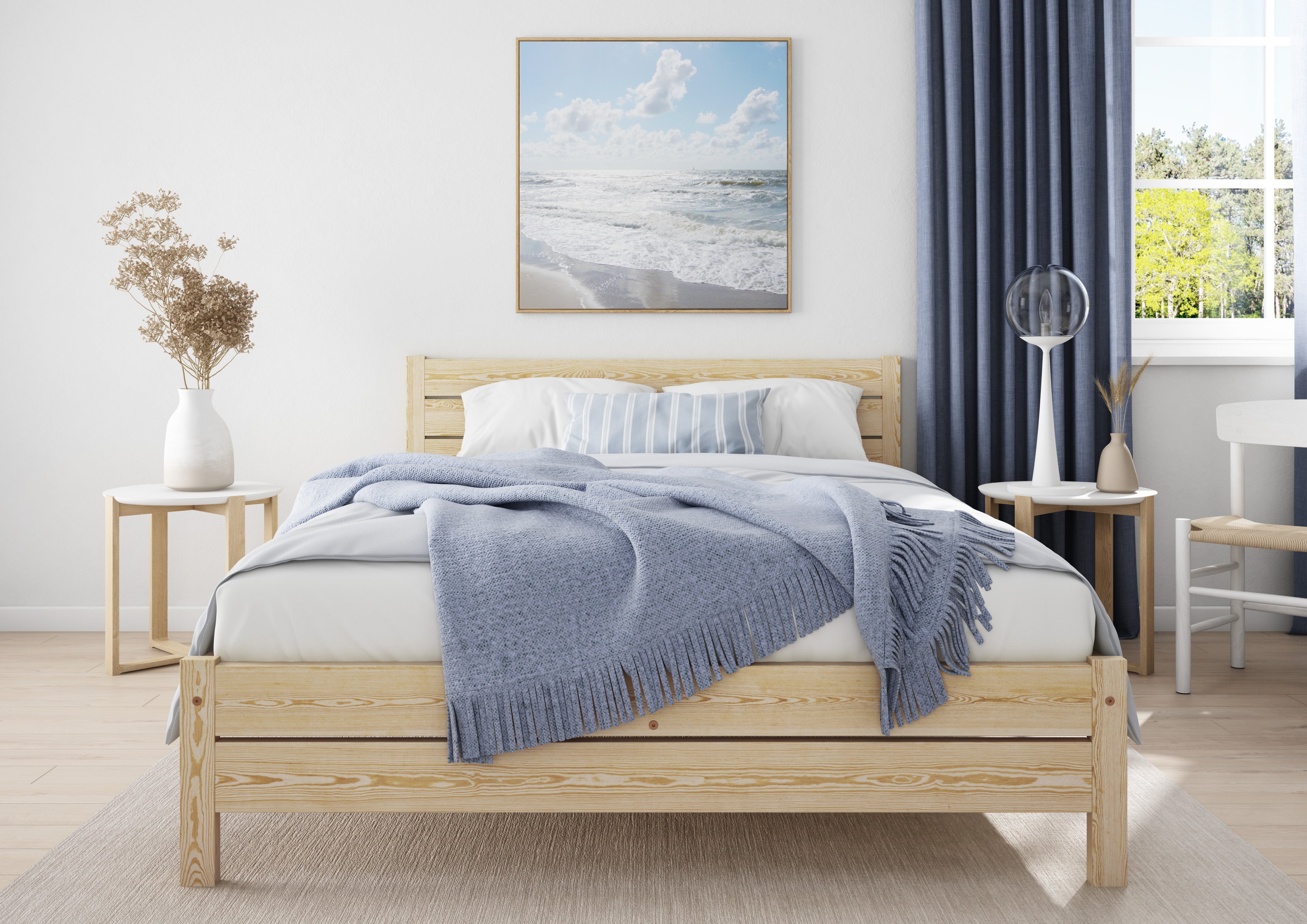 Wooden bed with white bedding and a blue blanket in a bedroom setting