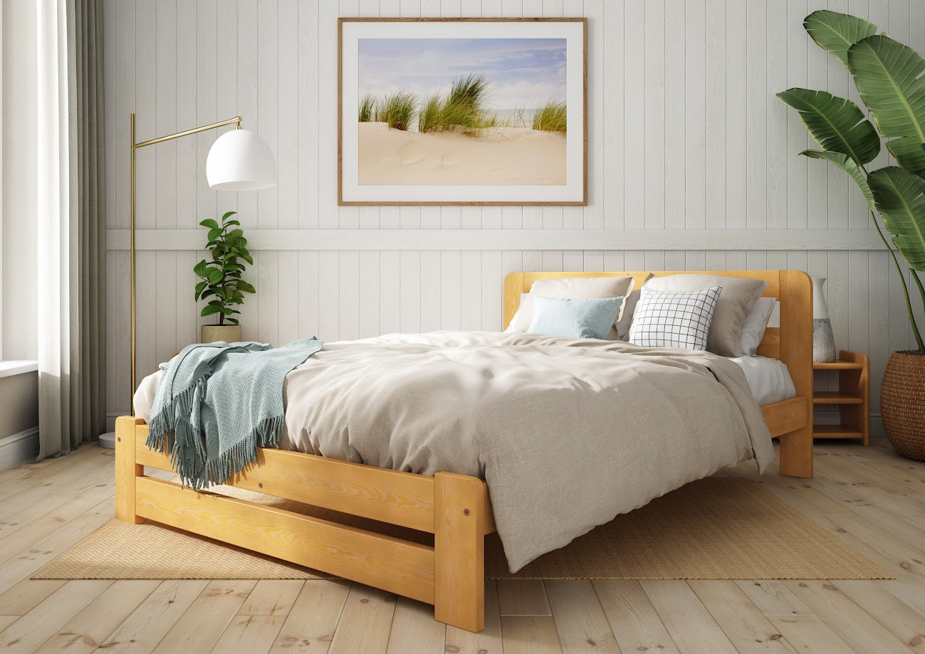 Wooden bed with grey bedding and a blue blanket in a bedroom setting