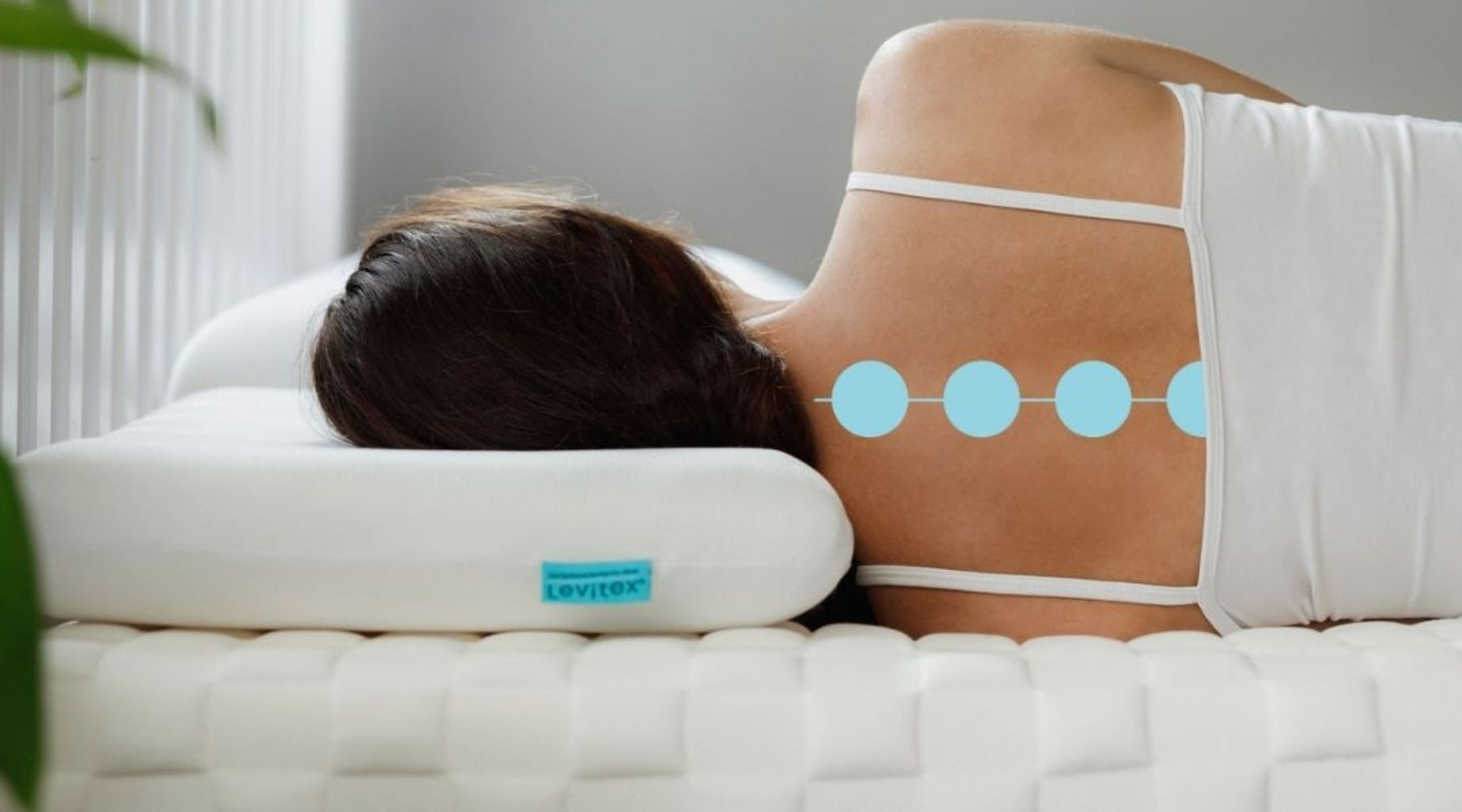 woman lying on her side in bed showcasing neutral neck alignment