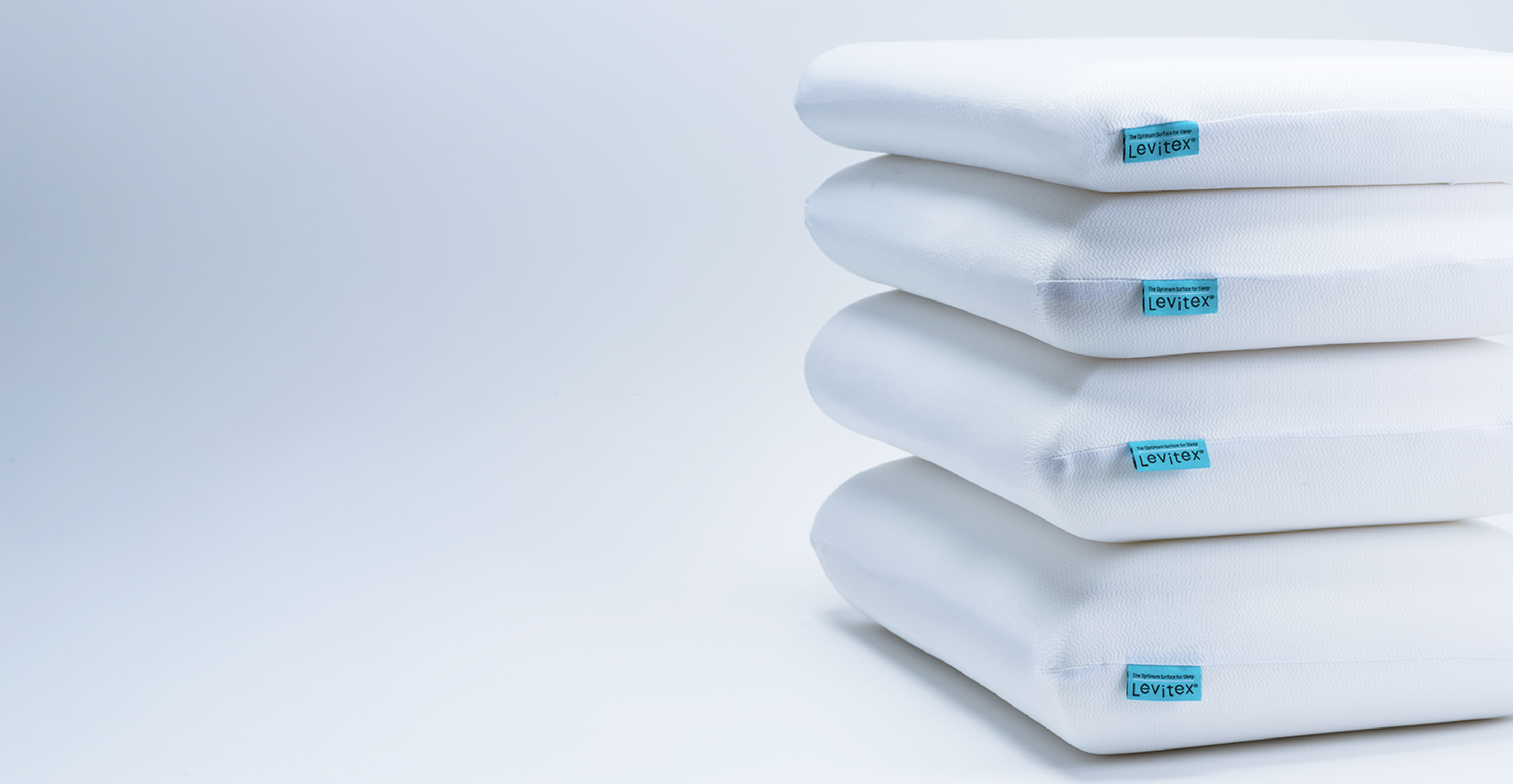 Stack of white pillows of different sizes