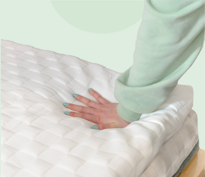 hand pushing a levitex mattress topper