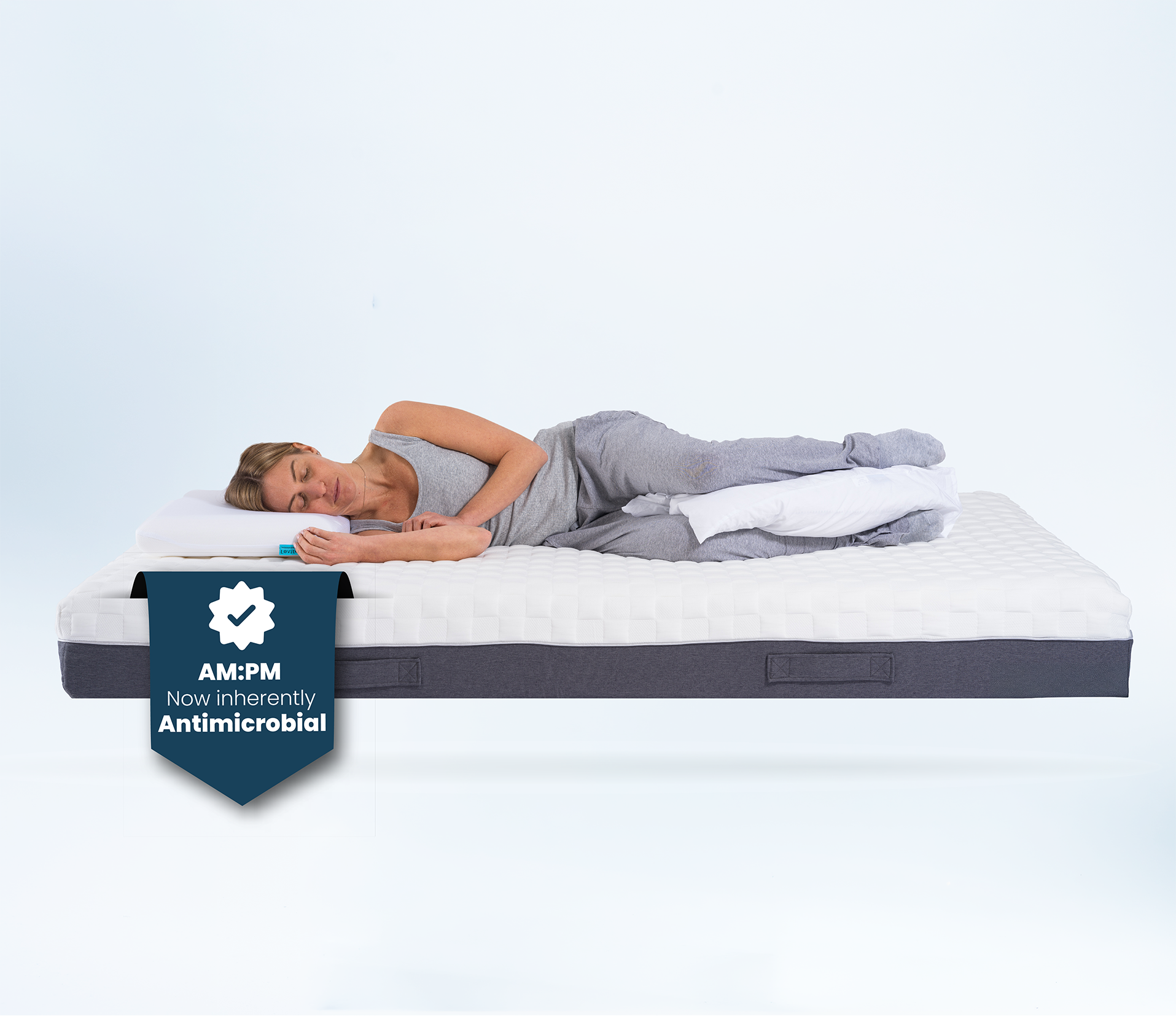 Person lying on a posture mattress with a white background