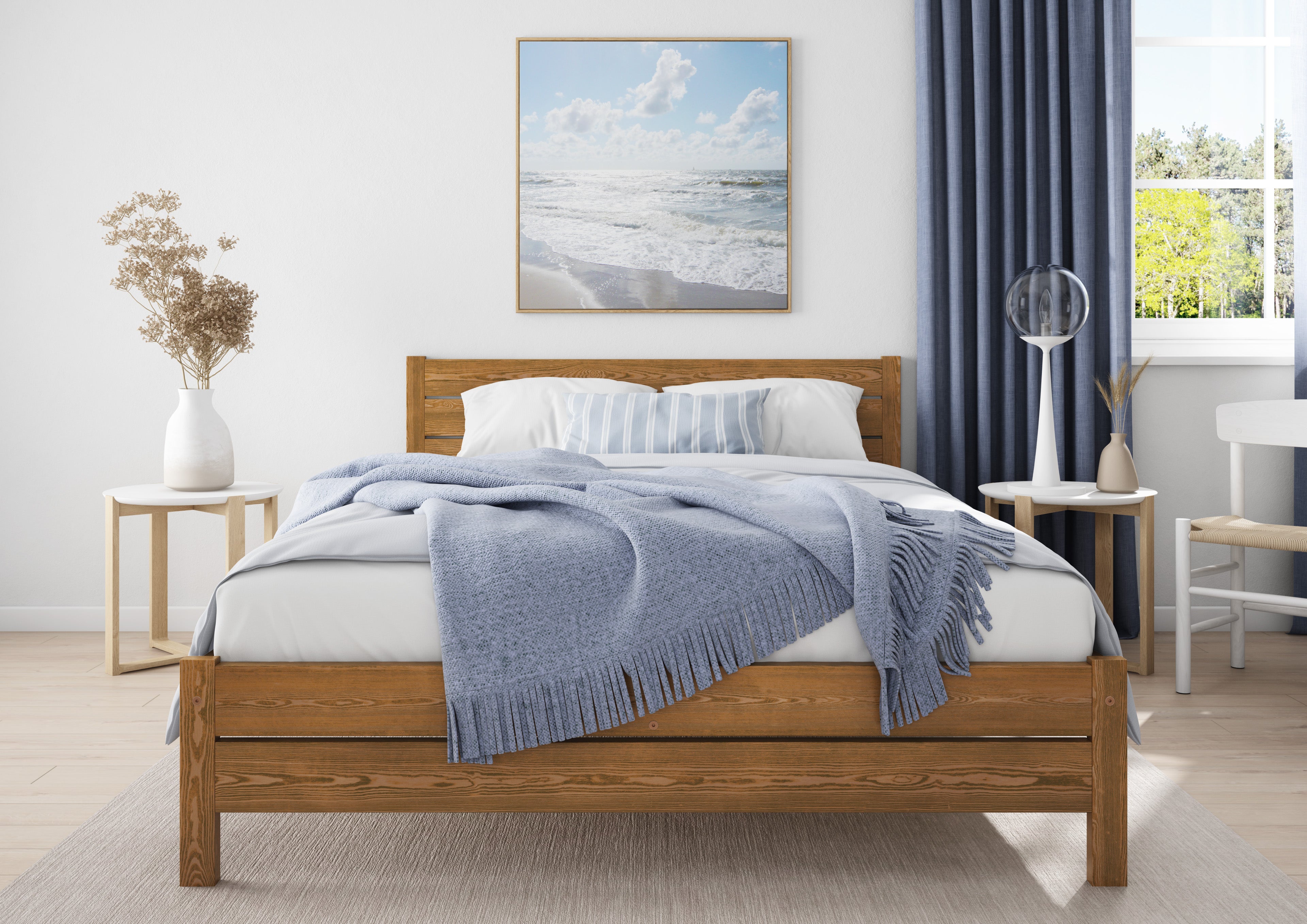 Wooden bed with white bedding and blue blanket in a bedroom setting.