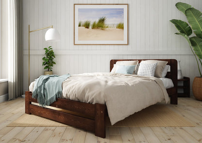 Wooden bed with grey bedding and a blue blanket in a bedroom setting