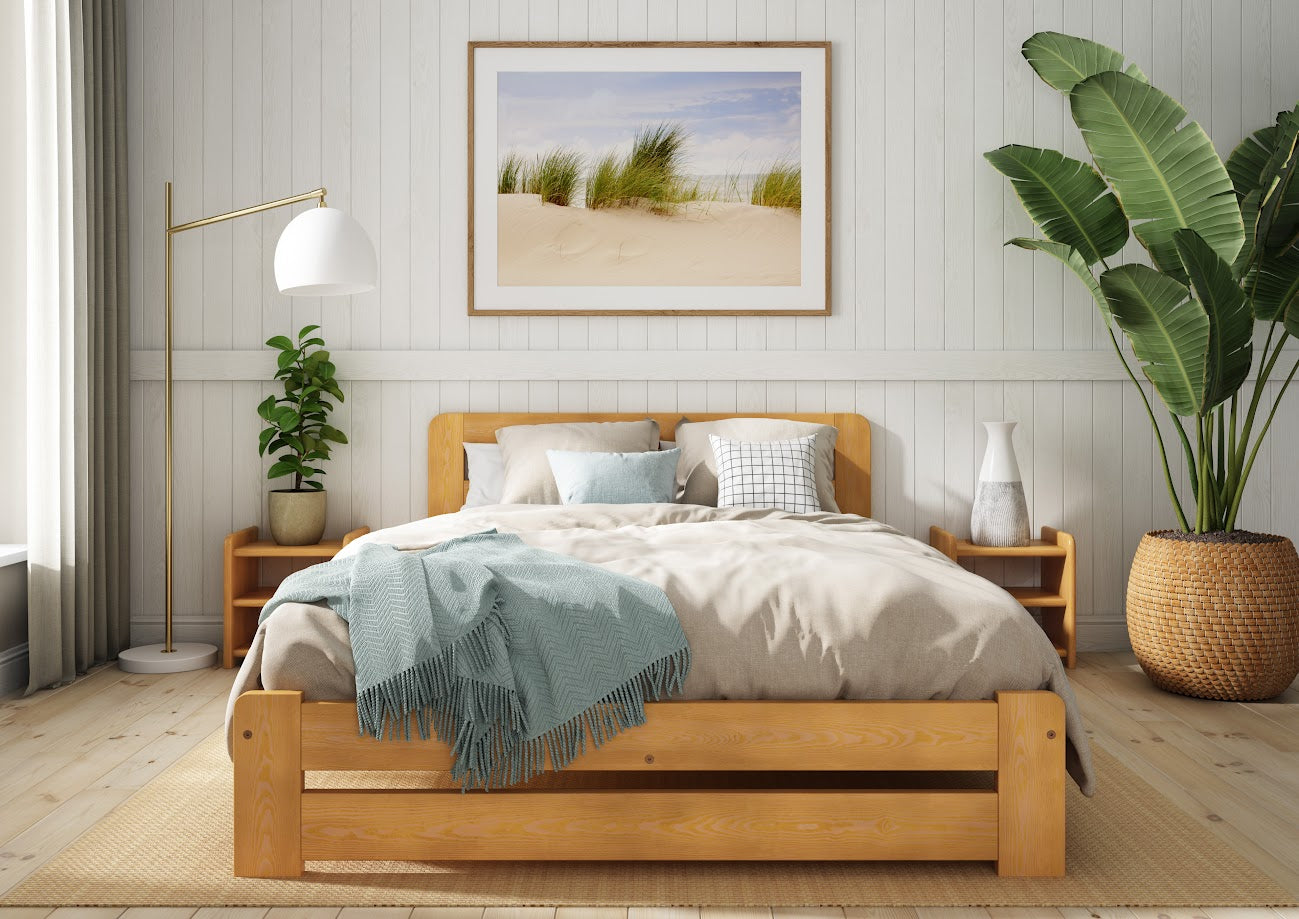 Wooden bed with grey bedding and a blue blanket in a bedroom setting