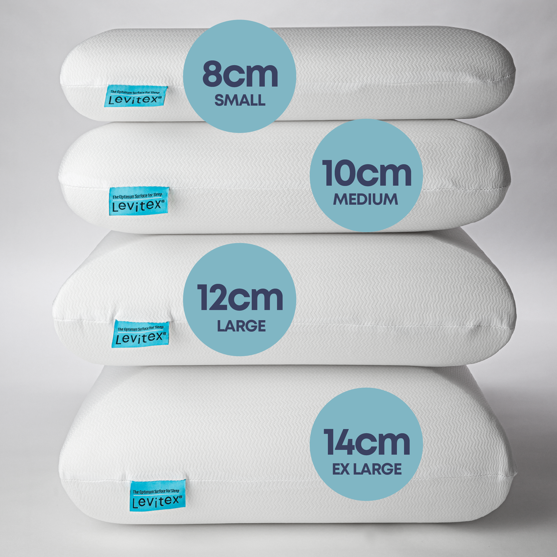 Different sized pillows stacked on one another